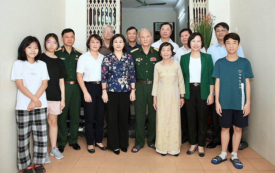 Các đồng chí lãnh đạo thành phố chụp ảnh lưu niệm với gia đình thương binh Nguyễn Thanh Bang (quận Thanh Xuân).