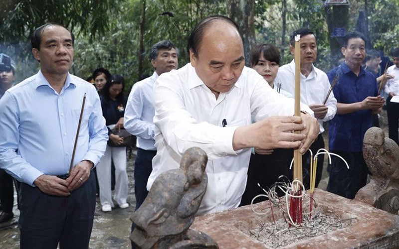 Chủ tịch nước Nguyễn Xuân Phúc cùng đoàn công tác dâng hương tưởng nhớ Chủ tịch Hồ Chí Minh tại lán Nà Nưa trong Khu di tích lịch sử quốc gia đặc biệt Tân Trào. Ảnh: TTXVN