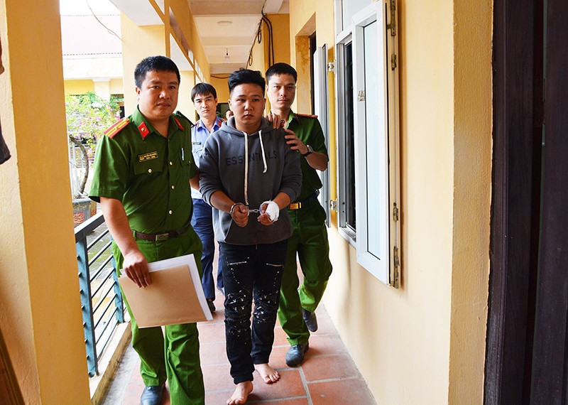 Cảnh sát áp giải đối tượng Phan Thanh Hoàng đi lấy lời khai