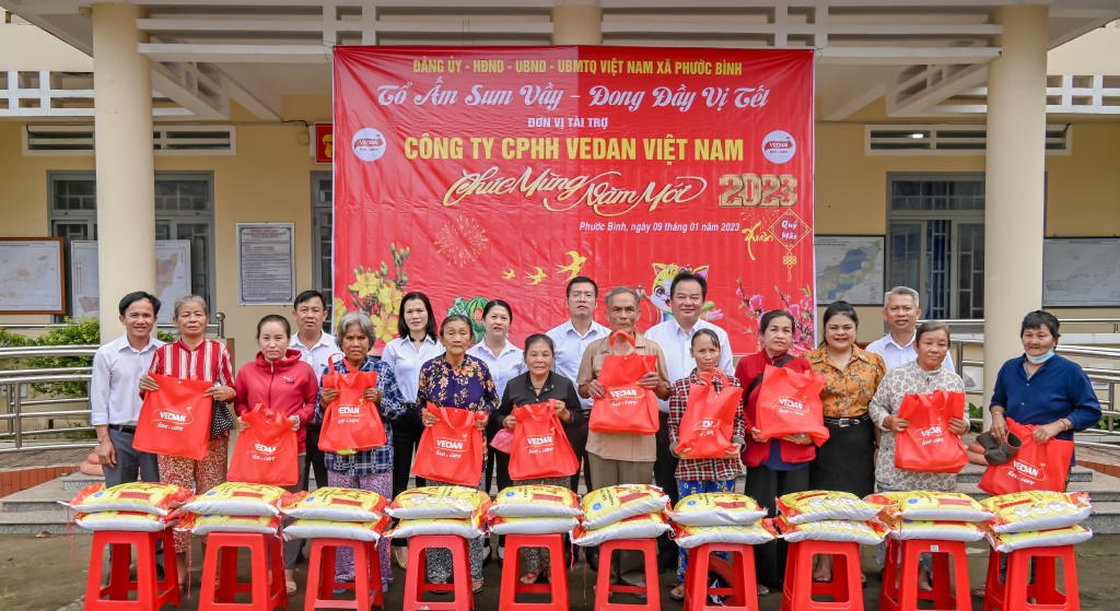 Bà Nguyễn Thu Thuỷ - Phó Giám đốc Đối ngoại Vedan Việt Nam (áo cam) đến trao quà Tết cho người dân tại xã Phước Bình