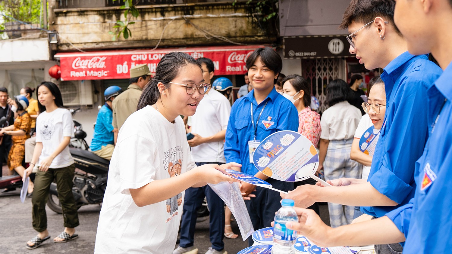 Sĩ tử đến điểm thi trường THPT Kim Liên (quận Đống Đa) được hỗ trợ quạt và nước uống miễn phí