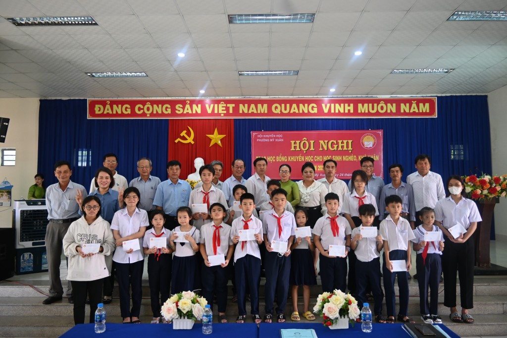 Bà Nguyễn Thu Thủy, Phó Giám đốc Đối ngoại công ty Vedan (thứ 5 phải qua) trao tặng học bổng khuyến học đến các em học sinh tại phường Mỹ Xuân, thị xã Phú Mỹ, tỉnh BRVT