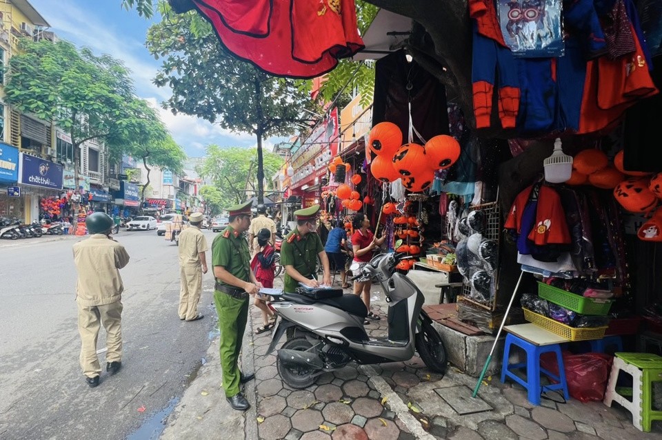 Một trường hợp lấn chiếm vỉa hè làm nơi kinh doanh bị các lực lượng chức năng phường Trung Liệt lập biên bản xử lý.