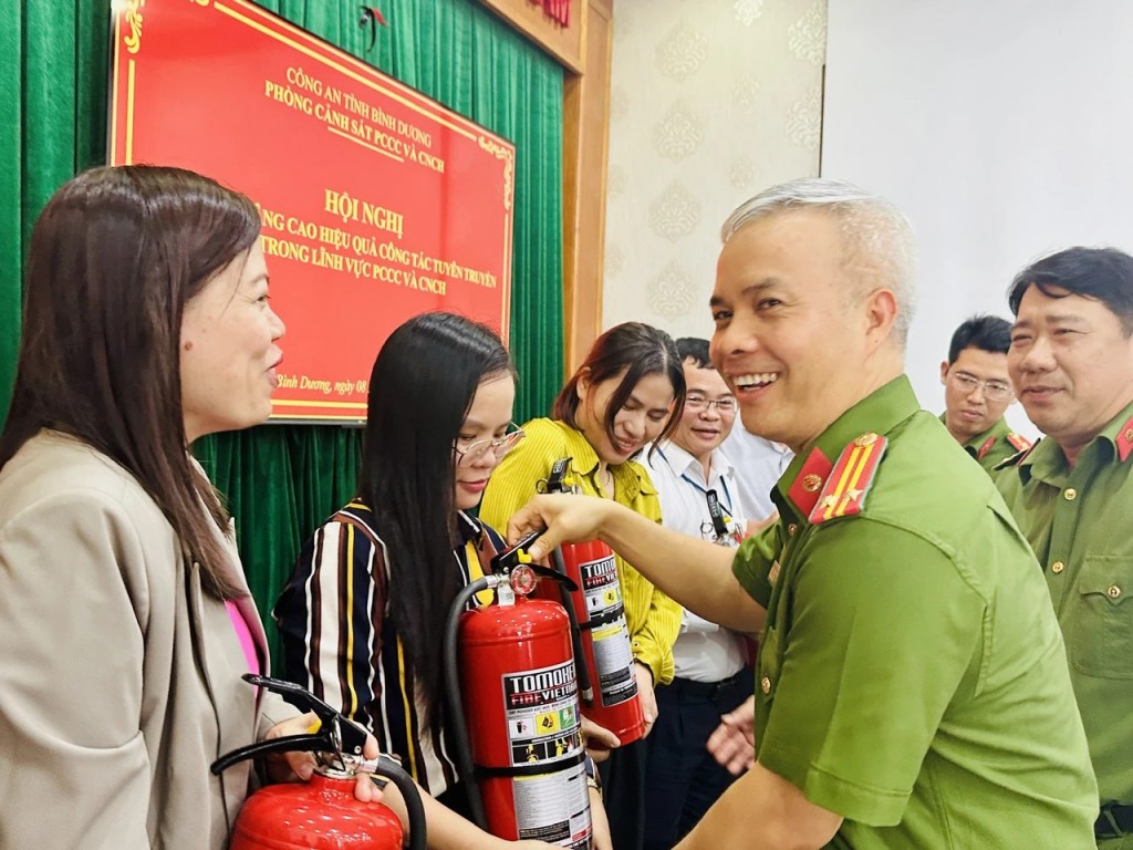  lãnh đạo Phòng Cảnh sát PCCC Bình Dương tặng bình chữa cháy cho phóng viên