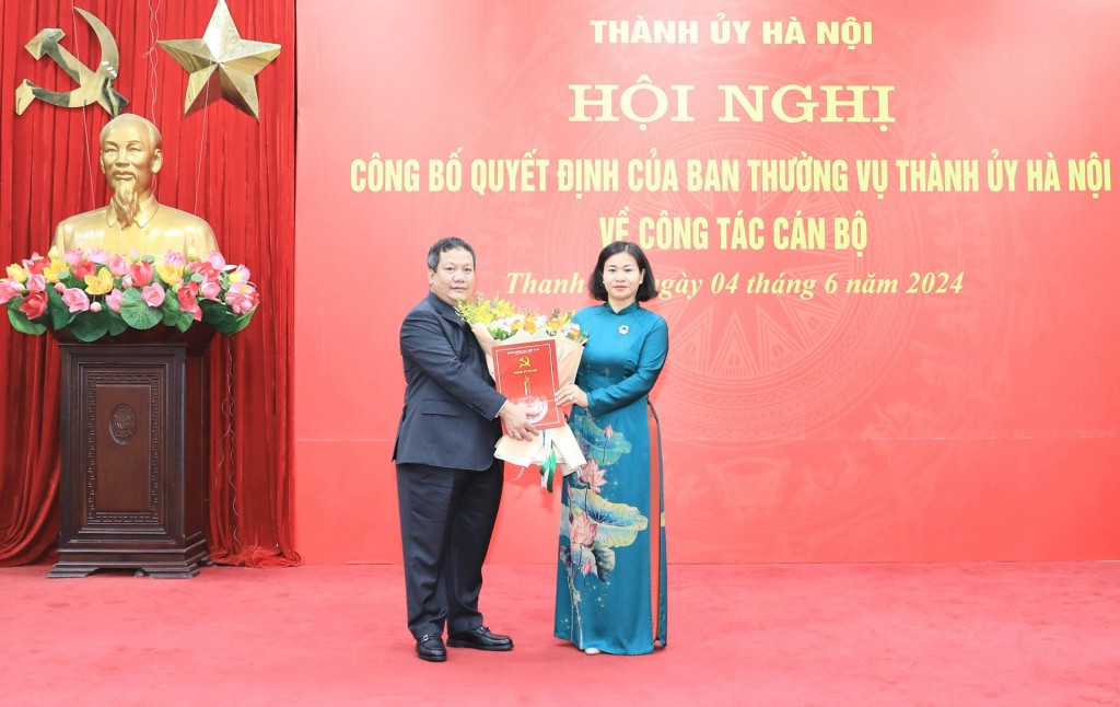 Phó Bí thư Thường trực Thành ủy Hà Nội Nguyễn Thị Tuyến trao quyết định, tặng hoa chúc mừng đồng chí Nguyễn Tiến Cường - Ảnh: Quang Thái