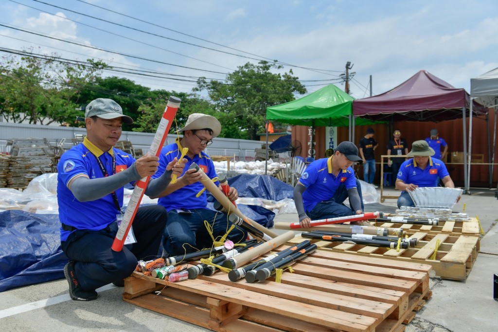 Dưới thời tiết nắng nóng, các thành viên trong đội pháo hoa Đà Nẵng đang gấp rút hoàn tất việc lắp đặt các dàn pháo