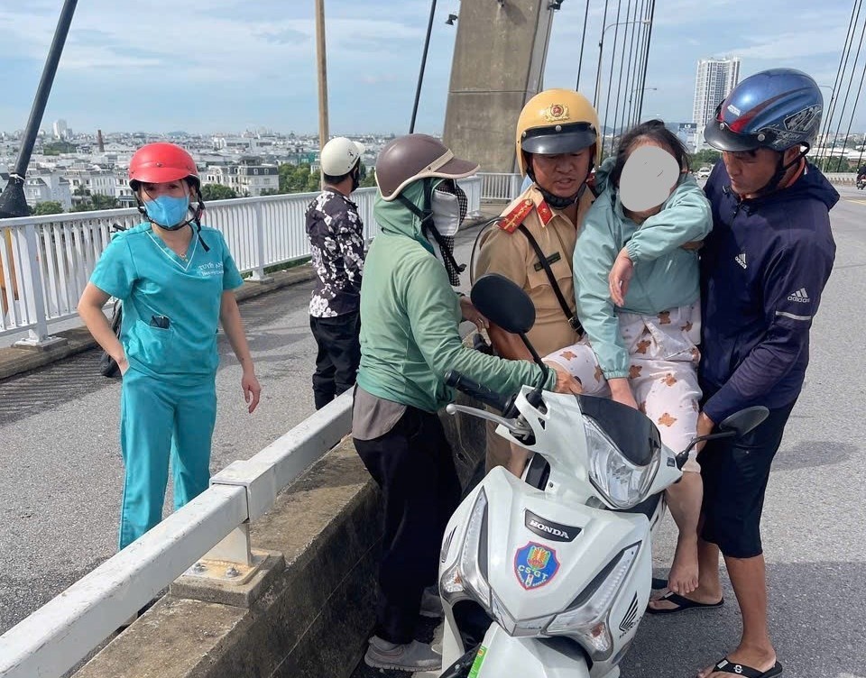 Đại úy Nguyễn Quang Hinh, đồng chí Phạm Văn Tuyền và bà con nhân dân giải cứu an toàn chị B.T.H trên cầu Bính, sáng 25/8/2024