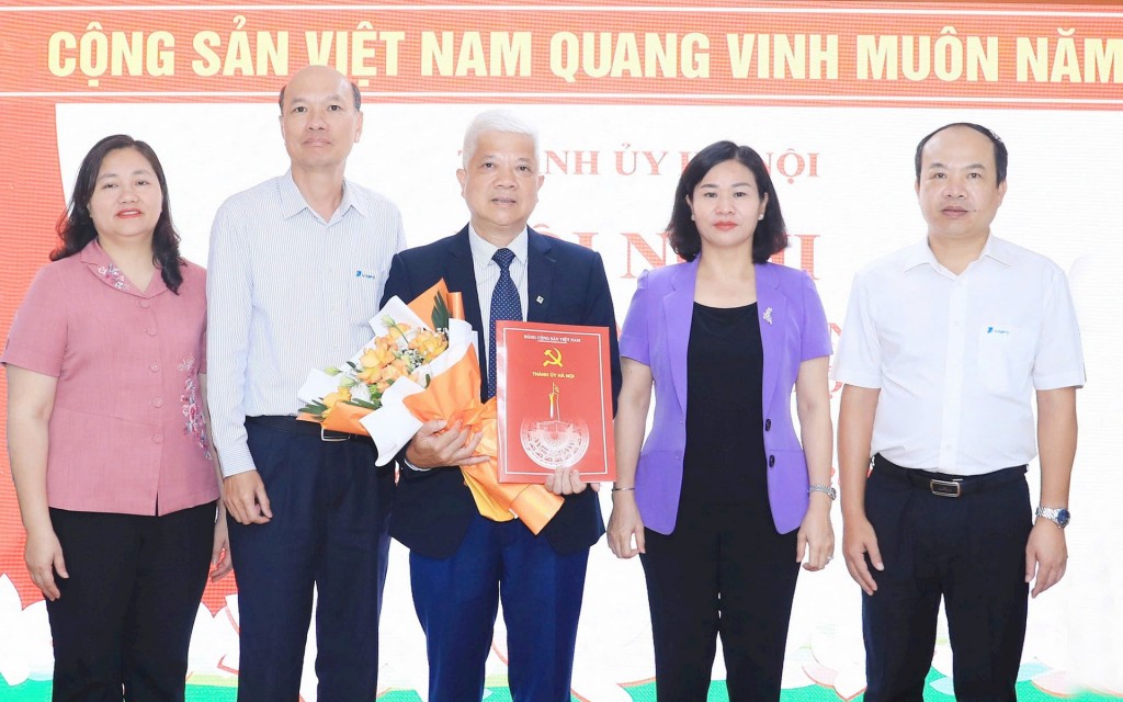 Phó Bí thư Thường trực Thành ủy Nguyễn Thị Tuyến tặng hoa chúc mừng đồng chí Nguyễn Hữu Chỉnh. Ảnh: Quang Thái