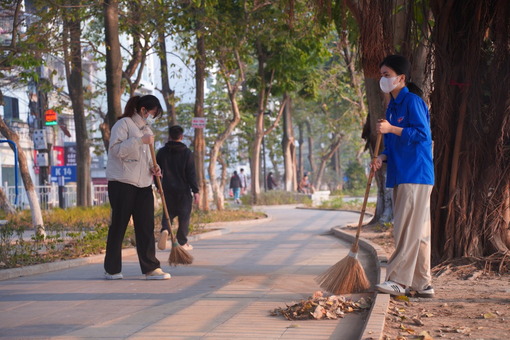 Lực lượng đoàn viên làm sạch đường đi, lá cây khu vực công viên hồ Xã Đàn