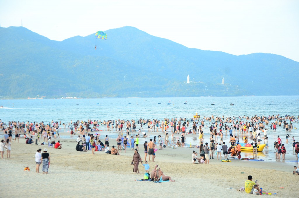 Dịp nghỉ lễ, bãi biển Mỹ Khê thu hút đông đảo du khách tắm biển và tham gia hoạt động thể thao, giải trí tại bãi biển (Ảnh Đ.Minh)