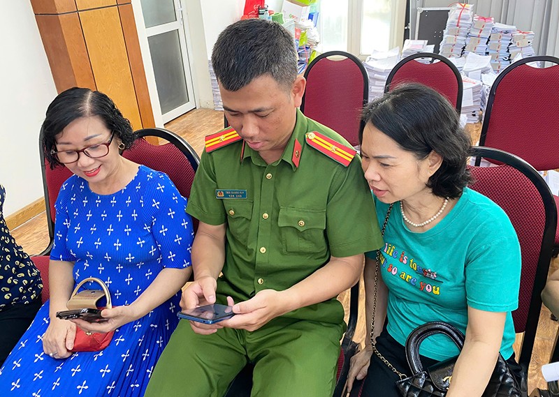 Cán bộ Cảnh sát khu vực Công an phường Bưởi trực tiếp hướng dẫn người dân sử dụng ứng dụng VNeID