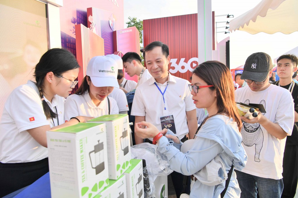 Phó Tổng Giám đốc Vietcombank Lê Hoàng Tùng giao lưu và cùng trải nghiệm dịch vụ với khách hàng tại gian hàng của Vietcombank