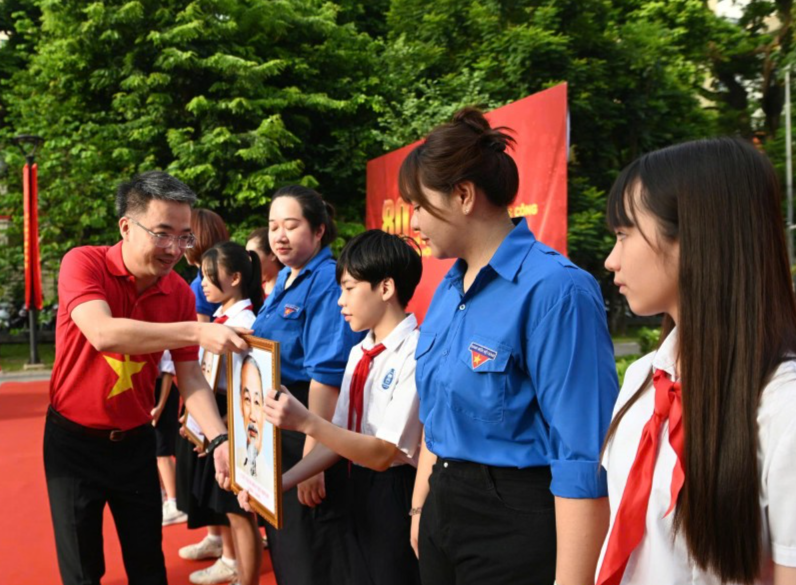 Anh Nguyễn Tường Lâm trao tặng ảnh Bác Hồ tới các em thiếu niên, nhi đồng