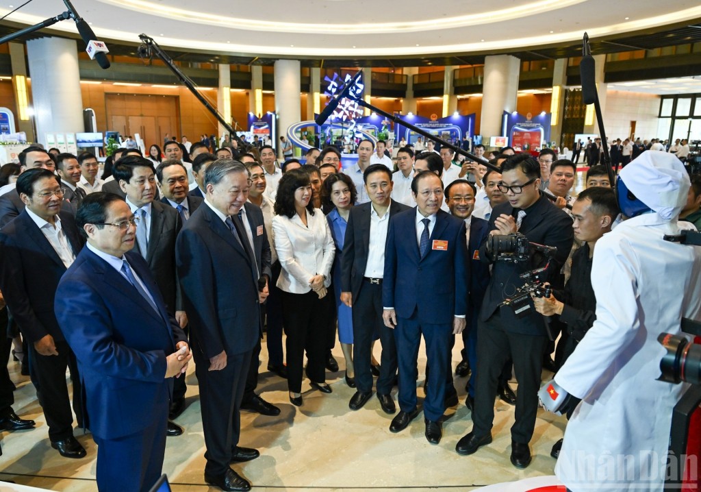 Tổng Bí thư Tô Lâm cùng các đồng chí lãnh đạo Đảng, Nhà nước và đại biểu nghe giới thiệu về những thành tựu trong lĩnh vực y tế.