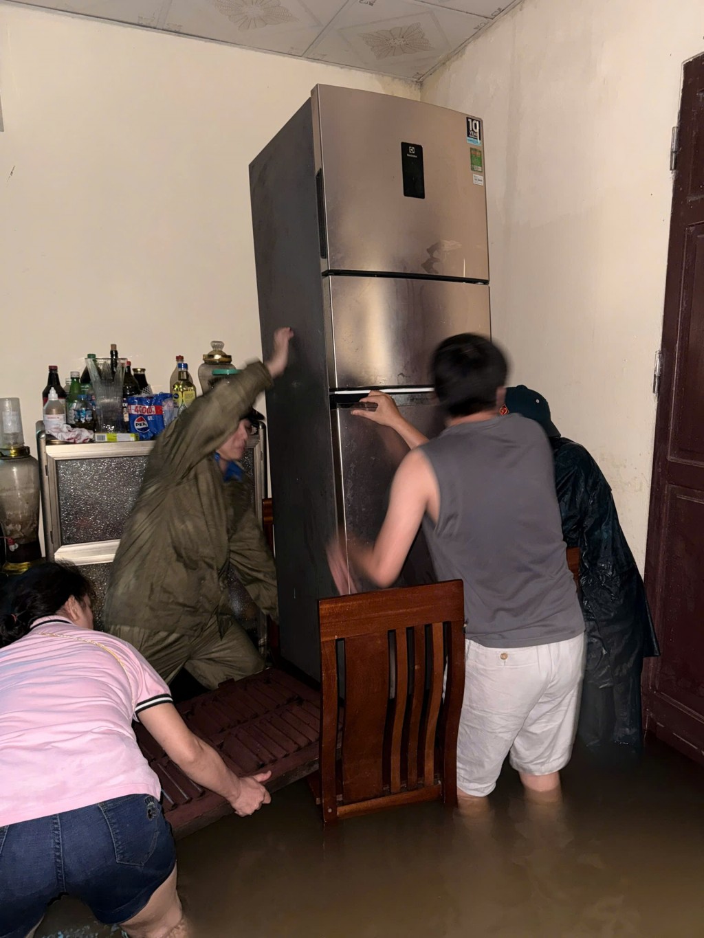 Lực lượng thanh niên, dân quân tự vệ phường Tây Mỗ hỗ trợ người dân bị ngập lụt kê cao tài sản, tránh thiệt hại