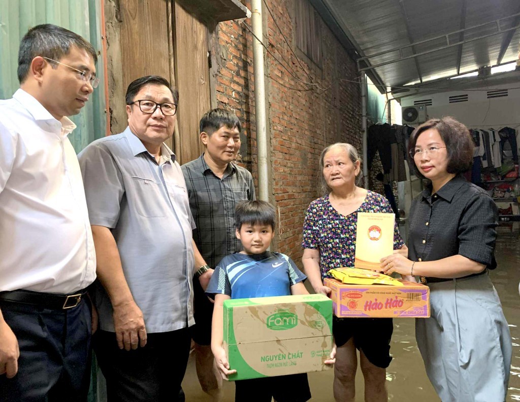 Phó Chủ tịch Thường trực Ủy ban Mặt trận Tổ quốc Việt Nam TP Hà Nội Bùi Huyền Mai cùng các đồng chí lãnh đạo phường Từ Liêm lội nước thăm hỏi, trao quà tới các hộ dân bị ngập úng ở Phú Đô