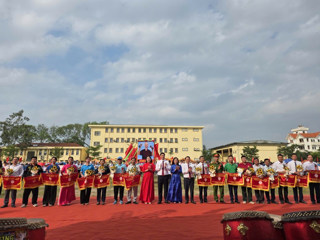 Các đồng chí trong Thường trực Đảng uỷ xã Quàng Bị trao cờ cho 18 đơn vị