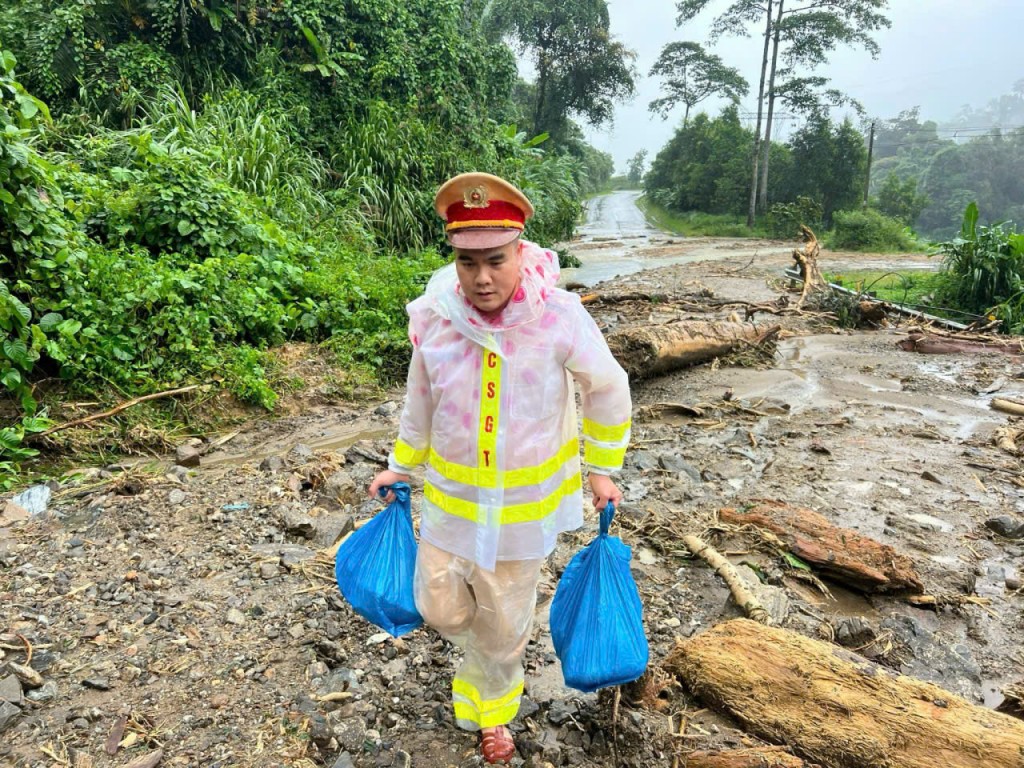 Các chiến sĩ CSGT băng rừng để mang các suất ăn đến với người dân và tài xế bị kẹt lại do sạt lở