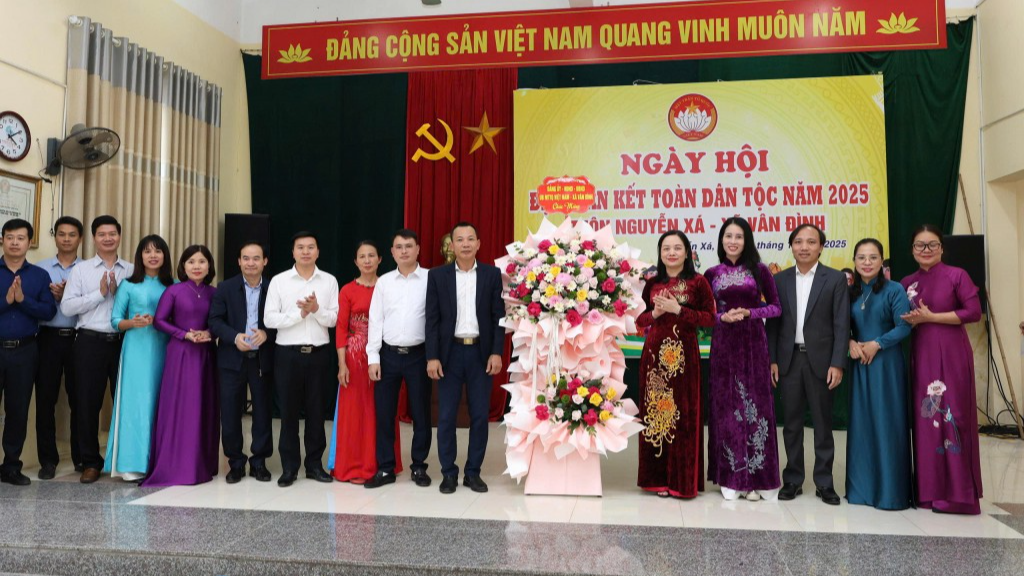 Lãnh đạo xã Vân Đình tặng hoa chúc mừng thôn Nguyên Xá tại Ngày hội Đại đoàn kết 