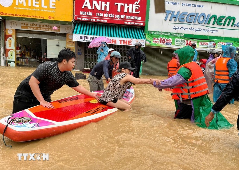 Sử dụng thuyền kayak đưa người dân vùng ngập lụt bị cô lập đến nơi an toàn. (Ảnh: Phan Sáu/TTXVN) Sử dụng thuyền kayak đưa người dân vùng ngập lụt bị cô lập đến nơi an toàn. (Ảnh: Phan Sáu/TTXVN)