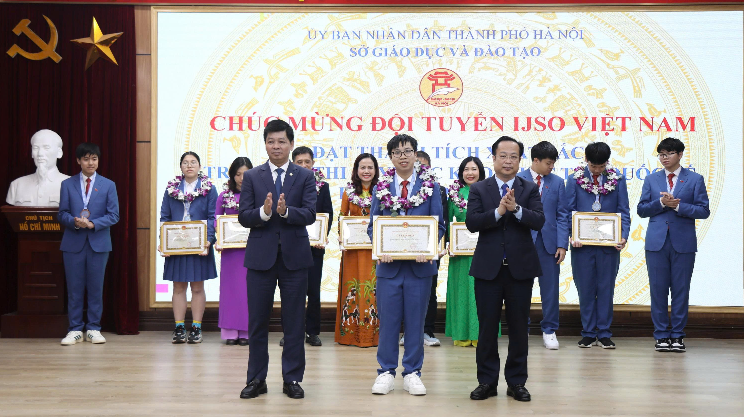 Phó Chủ tịch Thường trực HĐND TP Trần Thế Cương và Phó Giám đốc phụ trách Sở GD&ĐT Hà Nội Phạm Quốc Toản trao thưởng tới các học sinh.