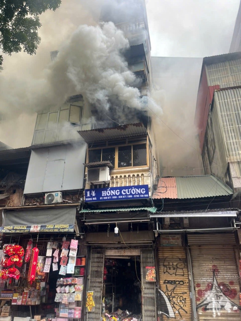 Khói đen cuồn cuộn bốc ra từ hiện trường vụ cháy nhà ở kết hợp kinh doanh tại 14 phố Hàng Mã