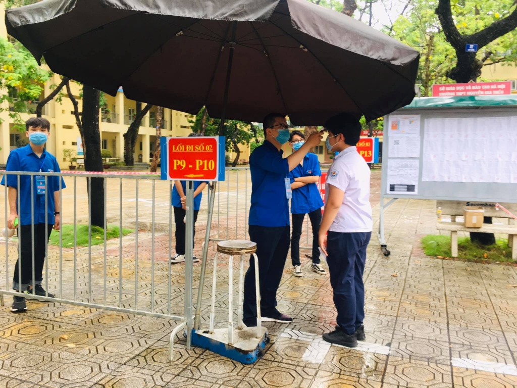 Áo xanh tình nguyện đội mưa hỗ trợ thí sinh tại các điểm thi