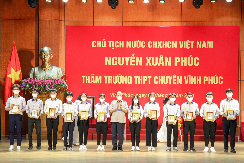 Chủ tịch nước Nguyễn Xuân Phúc tặng quà cho các học sinh đoạt giải cao qua các kỳ thi. (Ảnh: Thống Nhất/TTXVN)