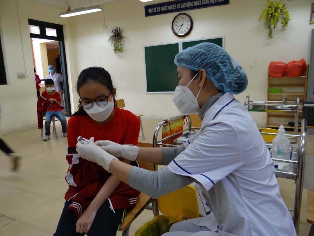 Trước khi tiêm, nhân viên y tế thông báo cho các em học sinh được biết loại vắc xin được tiêm và hạn sử dụng