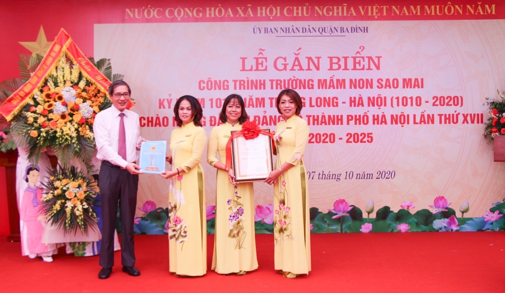 Bí thư Quận ủy Ba Đình Hoàng Minh Dũng Tiến trao chứng nhận và chụp ảnh lưu niệm tại Trường mầm non Sao Mai.