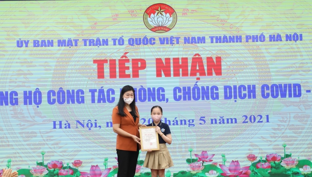 Chủ tịch Ủy ban MTTQ Việt Nam TP Nguyễn Lan Hương trap chứng nhận ủng hộ cho cháu Nguyễn Ngọc Trinh