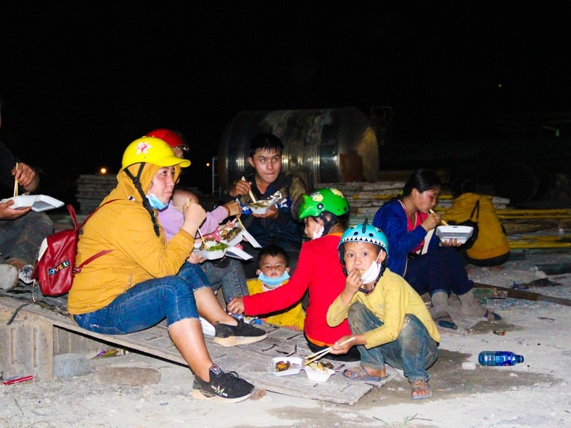 Gia đình chị Y Mái tranh thủ dùng cơm khi chờ xe trung chuyển qua hầm Hải Vân, TP Đà Nẵng 