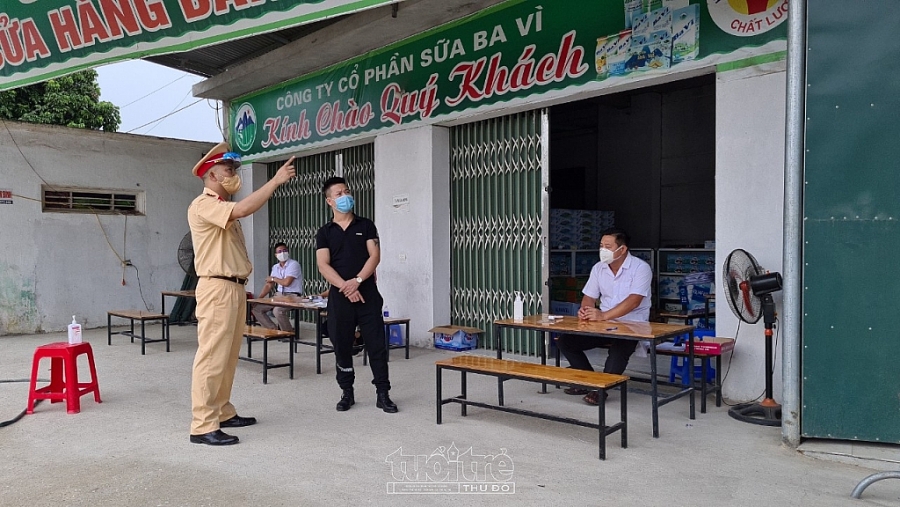 Anh Hùng (áo đen) nhường cả cửa hàng kinh doanh sữa cho lực lượng trực chốt chống dịch