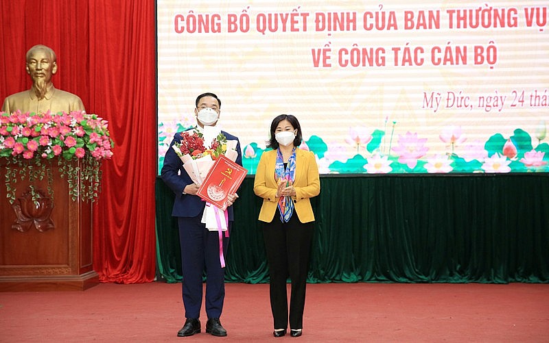 Phó Bí thư Thường trực Thành ủy Hà Nội Nguyễn Thị Tuyến trao Quyết định của Ban Thường vụ Thành ủy và tặng hoa chúc mừng đồng chí Nguyễn Ngọc Việt.