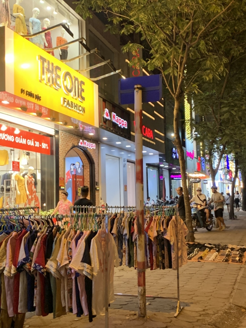 Các mặt hàng kinh doanh như quần áo, giày dép được bày bán la liệt khắp vỉa hè phố Chùa Bộc