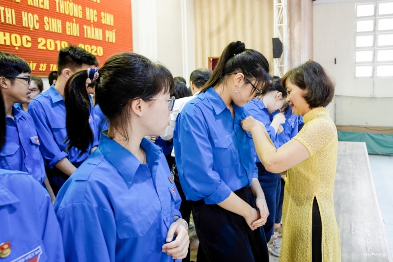 Cô giáo Hoàng Kim Uyên, Phó Hiệu trưởng phụ trách trường THCS Giảng Võ gắn huy hiệu Đoàn cho các em học sinh