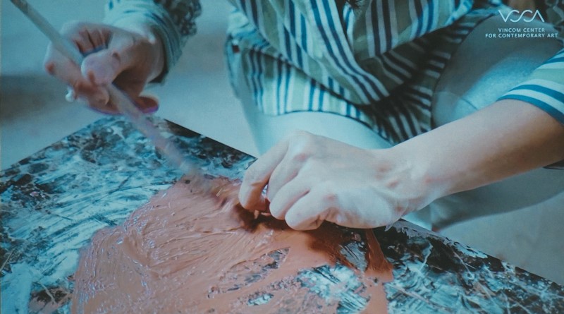 Nghệ sĩ Trần Thu Vân quét gốm trộn keo lên lá